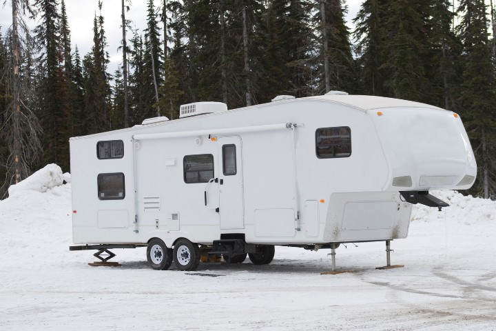 RV camper parked on a snowy ground