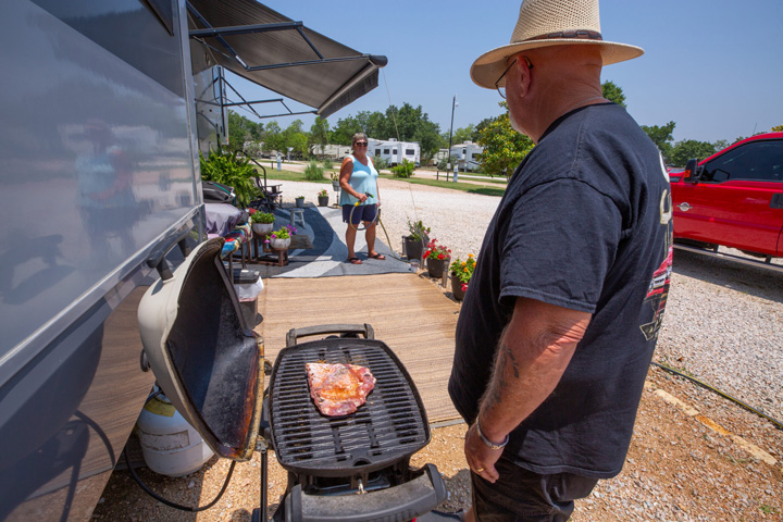 rv park guests grilling and watering plants
