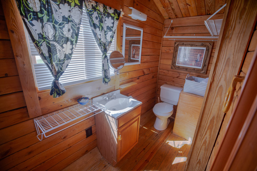 cabin bathroom at Johnson City campgrounds featuring wooden walls and modern amenities, Miller Creek RV Park
