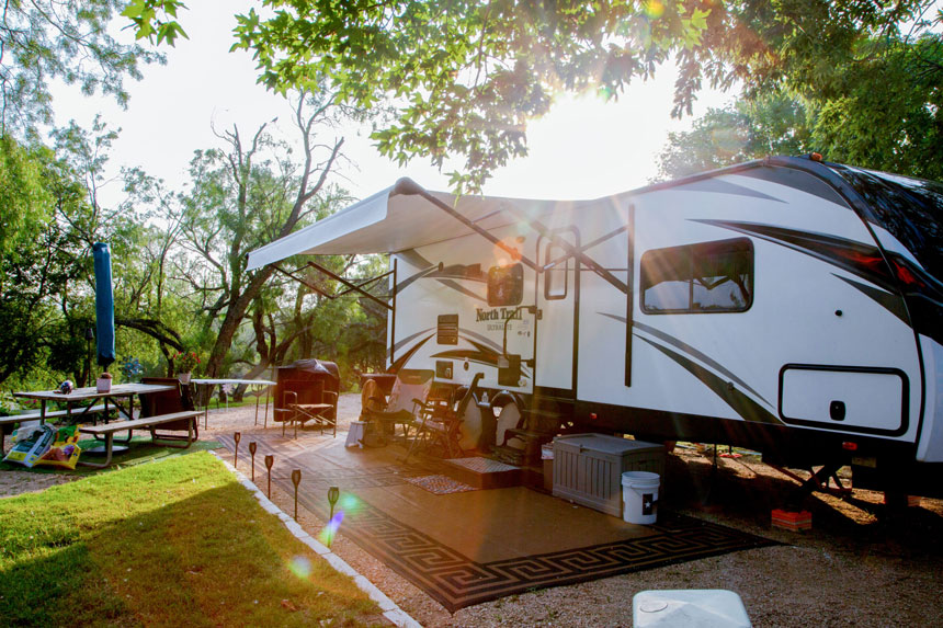 Creekside back-in RV site in Johnson City near Dripping Springs, TX, offering a spacious and serene rv camping experience with modern amenities
