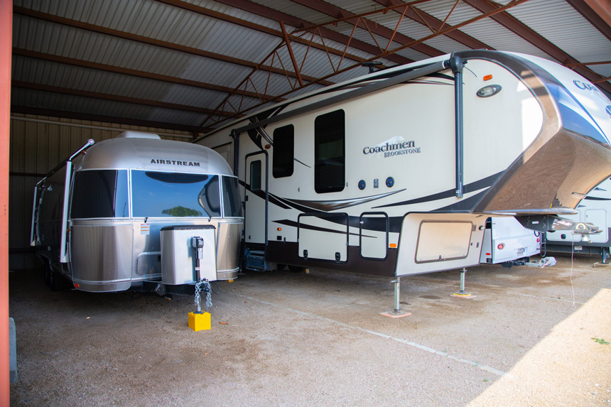 Airstream and a Coachmen Brookstone RV parked at an RV storage facility near Dripping Springs, and Blanco, TX