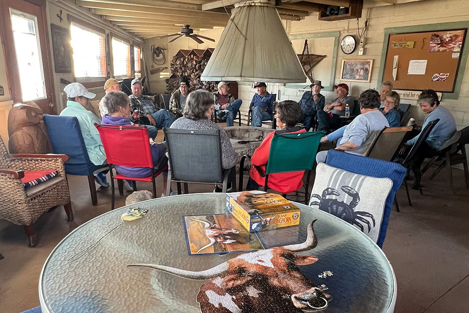 Cozy indoor gathering of Miller Creek RV park residents around a central fireplace