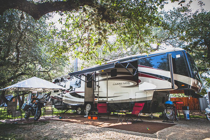 Shaded RV campsite at Mystic Quarry Resort with outdoor seating