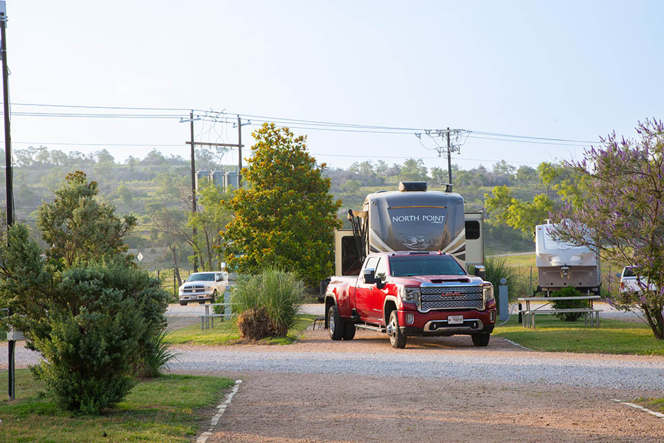 Spacious back-in RV site with a red truck and RV setup near blanco texas