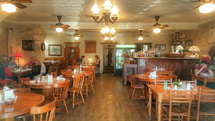 Guests enjoying meals inside Der Lindenbaum, a historic restaurant in Fredericksburg, Texas