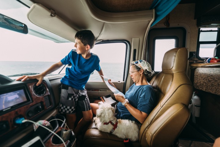 A woman managing expenses inside an RV, illustrating the importance of budgeting for full-time RVers