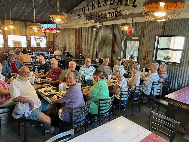 Large group dining at a rustic restaurant in Fredericksburg, Texas