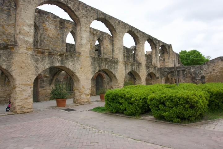 Historic stone arches of a Spanish colonial mission in San Antonio, showcasing unique architecture