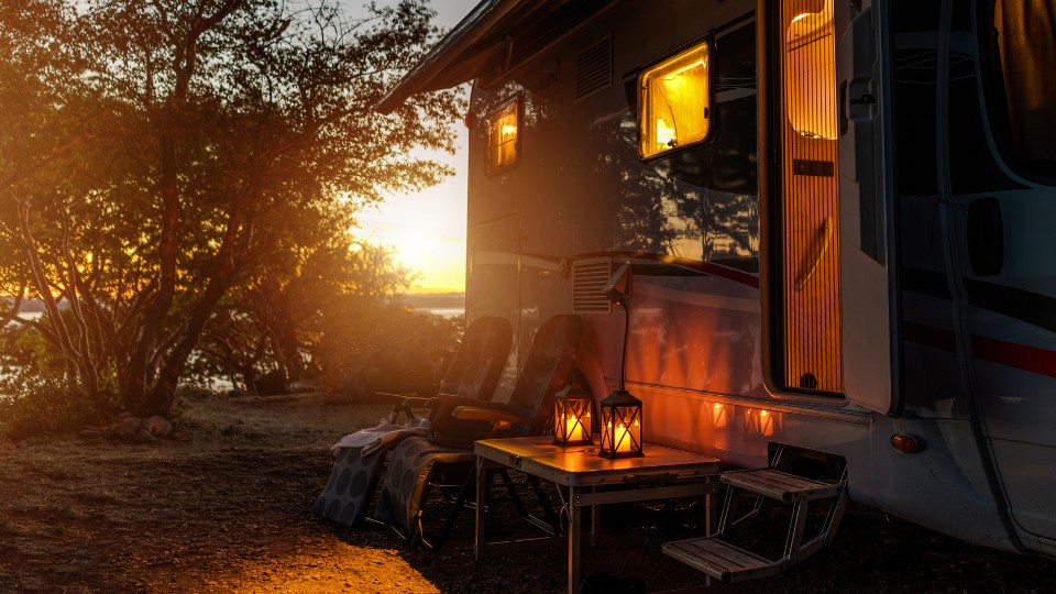 Cozy RV campsite at sunset with solar lanterns