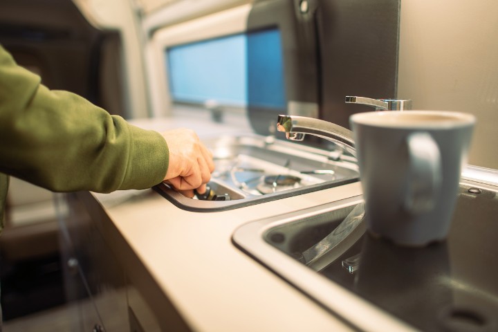 RVer practicing storm safety by turning off stove