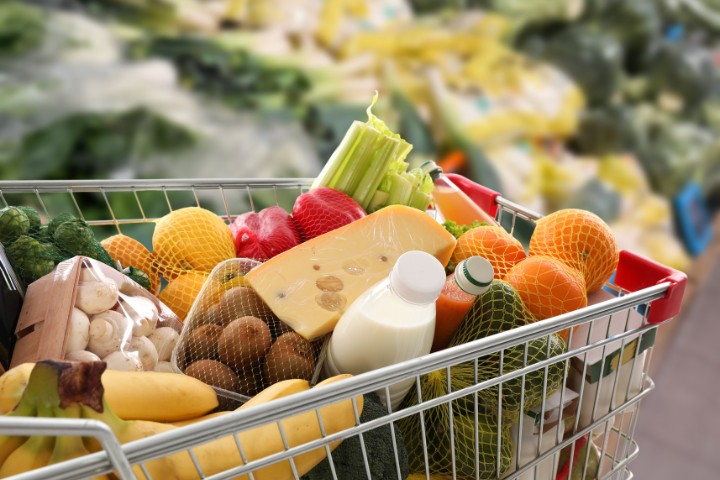 Grocery cart filled with fresh food and camping essentials for an RV trip in the Hill Country