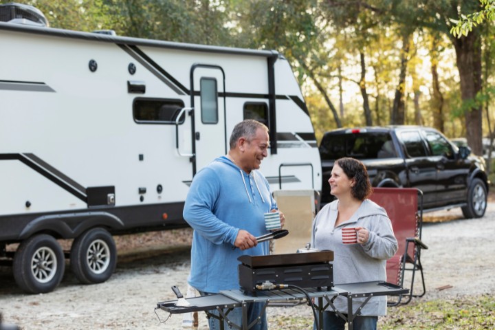 RVers cooking outdoors on a propane stove at a campground near Fredericksburg
