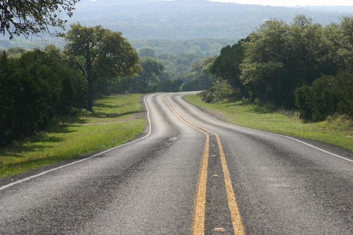 Scenic Texas Hill Country road leading toward Fredericksburg for an RV camping trip