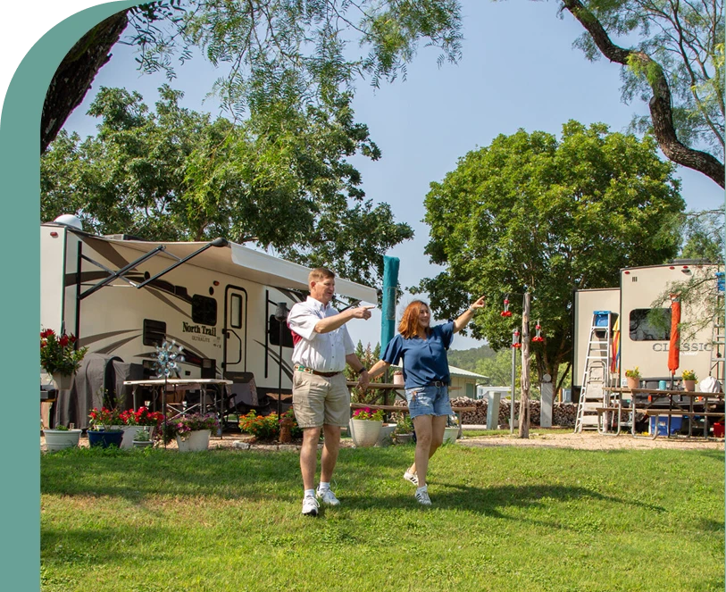 Couple walking through a landscaped RV park near Austin, Texas