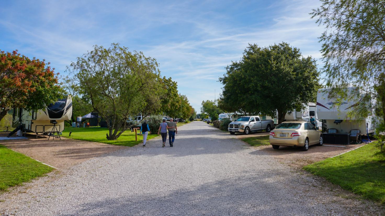 Peaceful RV park near san antonio with gravel road and parked RVs