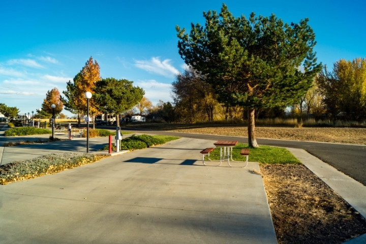 Paved RV campground sites with electrical hookup posts and a picnic table