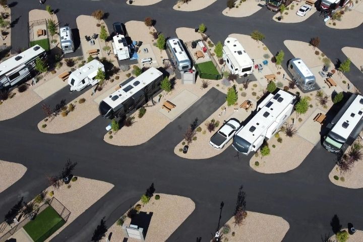 Aerial view of pull-through and back-in RV sites arranged throughout an RV park