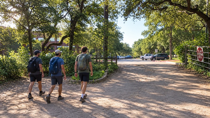 Three hikers exiting 360 Access Trailhead in the afternoon