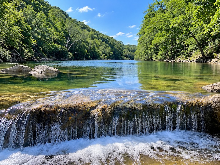 Small limestone waterfall and swimming area along Barton Creek