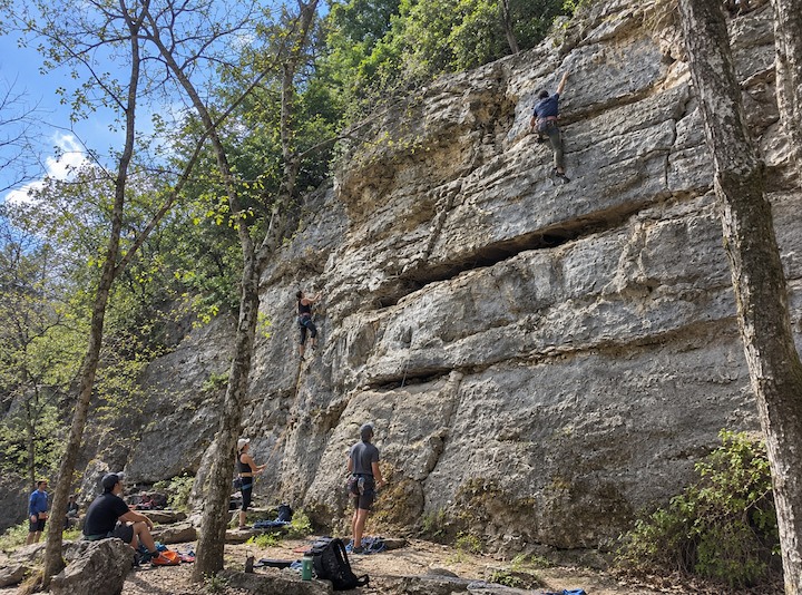 Rock climber ascending a limestone cliff at Barton Creek Greenbelt Gus Fruh Trailhead