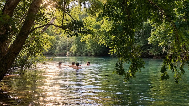 Natural swimming hole surrounded by trees at Barton Creek Greenbelt